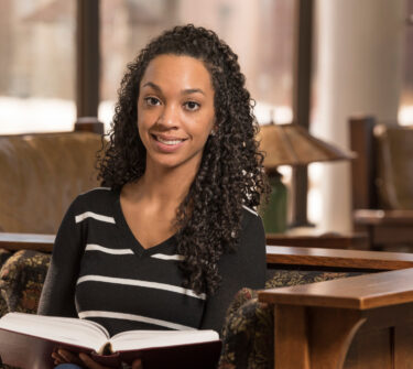 Kelly Maxwell smiles in the USD School of Law library.